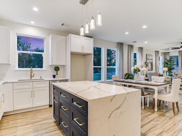 570 Quick Draw, Horseshoe Bay, TX 78657 - kitchen with a sink, white cabinetry, light wood finished floors, hanging light fixtures, and a ceiling fan