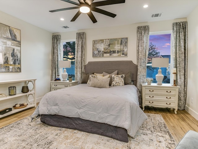 bedroom with ceiling fan and light wood-type flooring