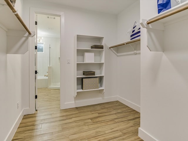 walk in closet featuring light hardwood / wood-style flooring