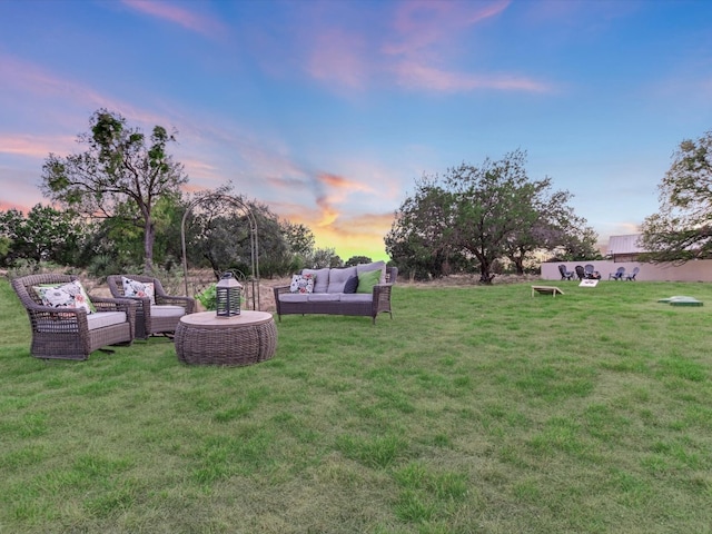 yard at dusk featuring an outdoor hangout area