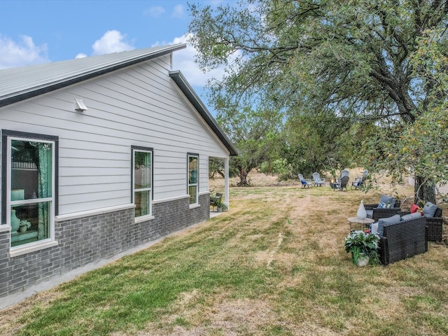 view of side of home featuring a yard