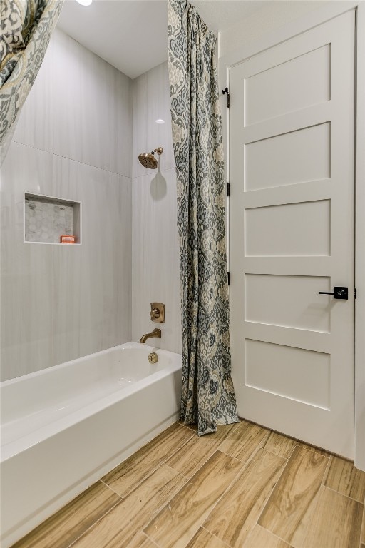 bathroom featuring shower / bath combination with curtain and hardwood / wood-style flooring