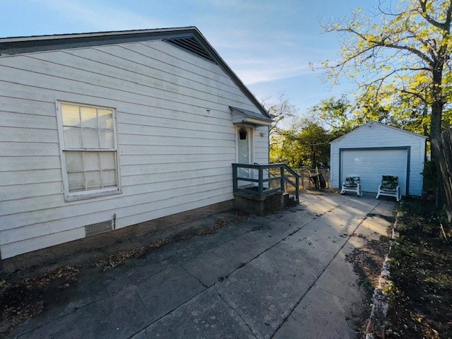 view of side of home with an outdoor structure and a garage