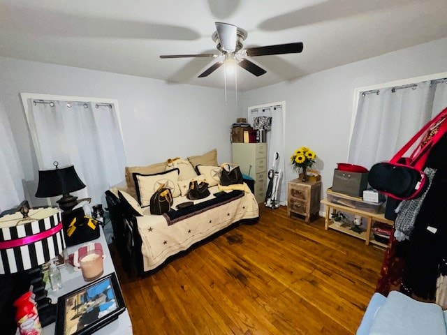 bedroom with dark wood-type flooring and ceiling fan