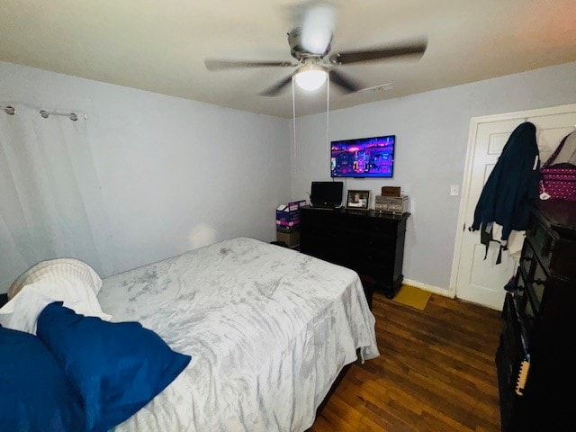 bedroom featuring dark hardwood / wood-style flooring and ceiling fan