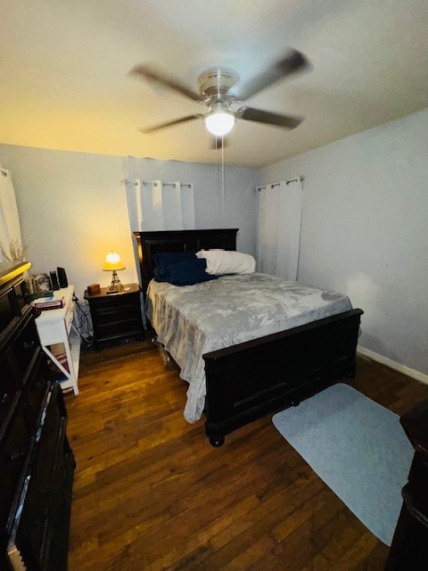 bedroom with ceiling fan and dark hardwood / wood-style flooring