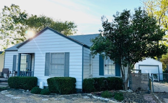 view of home's exterior featuring an outdoor structure and a garage