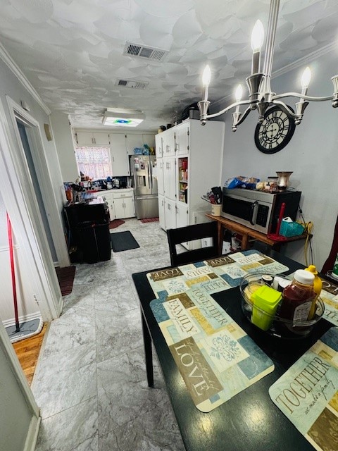 dining space with crown molding