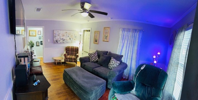 living room featuring ornamental molding, wood-type flooring, vaulted ceiling, and ceiling fan