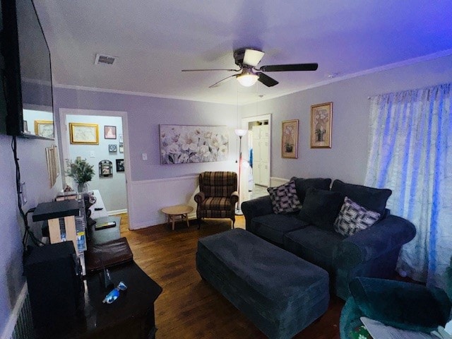 living room with crown molding, ceiling fan, and dark hardwood / wood-style flooring