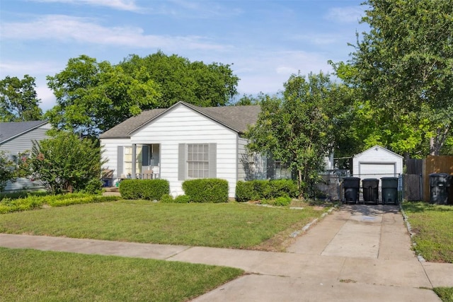 1514 S 13th St, Temple, TX 76504 - view of front of house with concrete driveway, a gate, a shingled roof, a detached garage, and an outbuilding