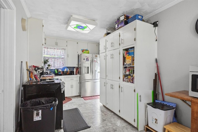 1514 S 13th St, Temple, TX 76504 - kitchen with stainless steel refrigerator with ice dispenser, crown molding, and white cabinetry