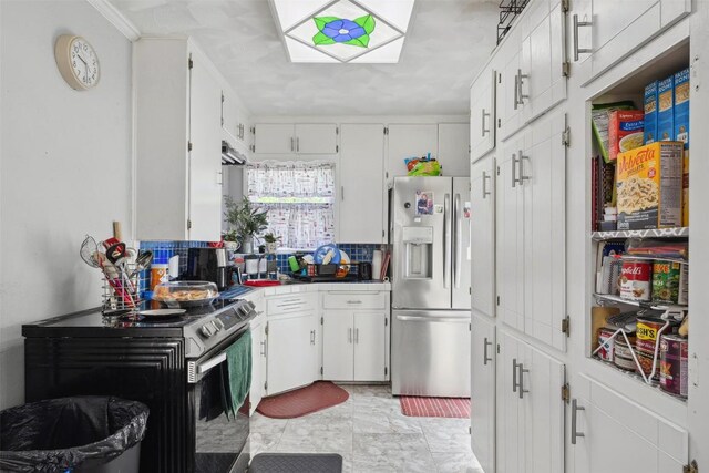 1514 S 13th St, Temple, TX 76504 - kitchen with appliances with stainless steel finishes, white cabinetry, crown molding, and decorative backsplash