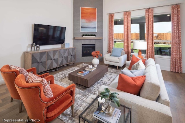 living room with hardwood / wood-style floors, a healthy amount of sunlight, and a fireplace