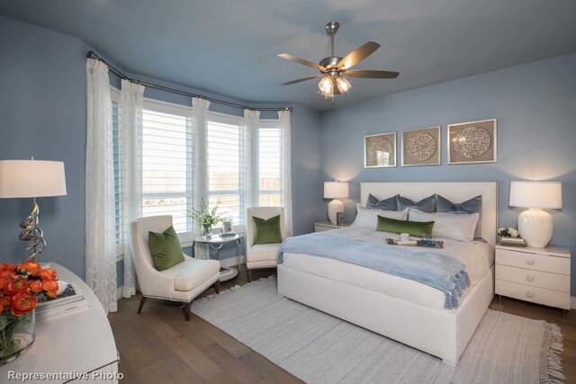 bedroom with ceiling fan and dark hardwood / wood-style flooring