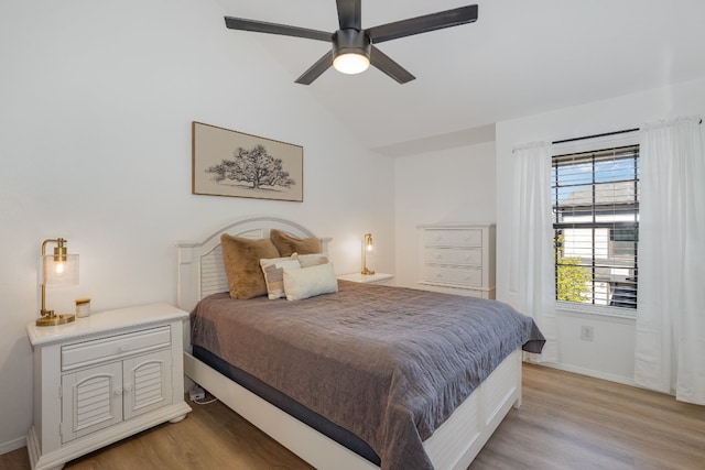 bedroom featuring lofted ceiling, light hardwood / wood-style floors, and ceiling fan