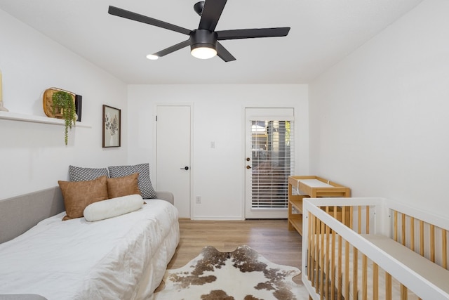 bedroom with ceiling fan and light hardwood / wood-style flooring