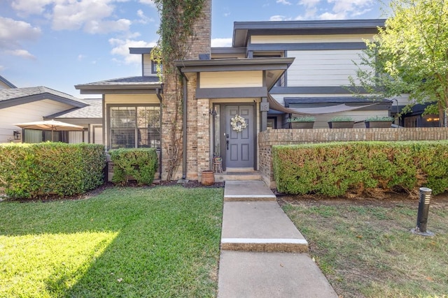 doorway to property featuring a lawn