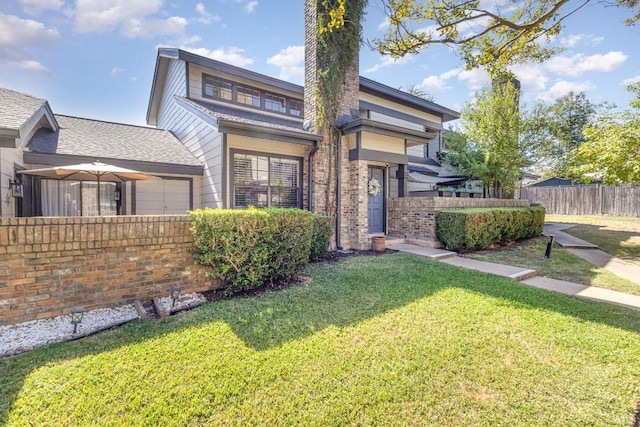 view of front of home with a garage and a front yard