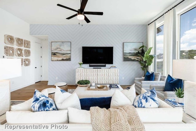 living room featuring ceiling fan and wood-type flooring