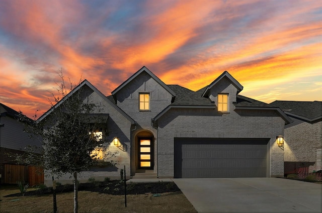 french provincial home featuring a garage