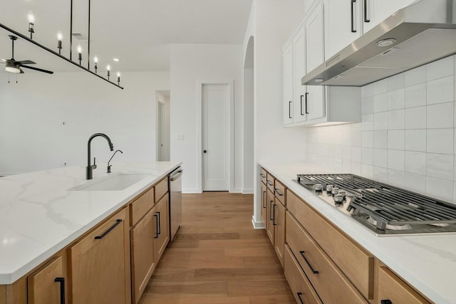 kitchen featuring white cabinetry, sink, light stone counters, and stainless steel appliances