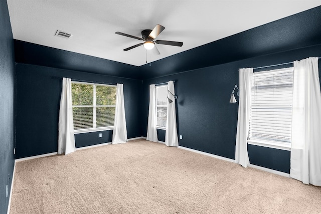 carpeted empty room featuring ceiling fan