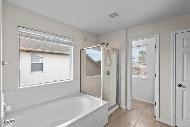 bathroom with tile patterned floors and separate shower and tub