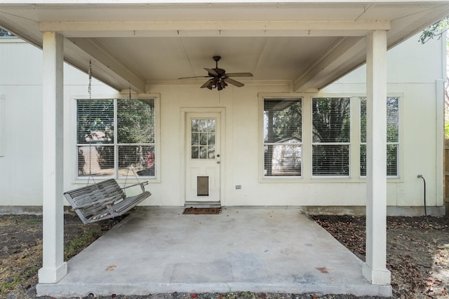 doorway to property with ceiling fan and a patio area