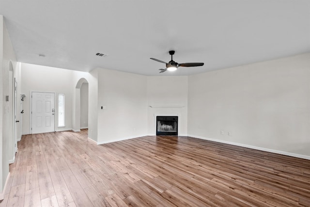 unfurnished living room with ceiling fan and light wood-type flooring