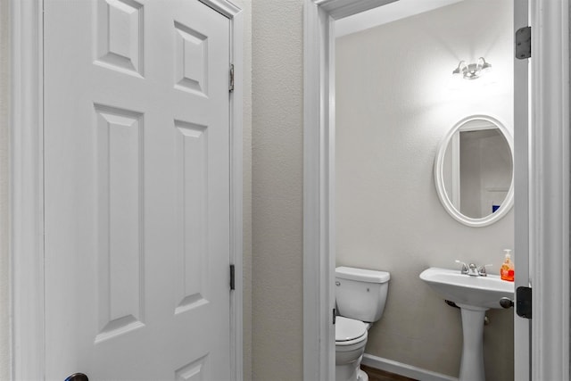 bathroom featuring toilet and sink