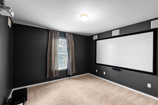 carpeted home theater room with a textured ceiling