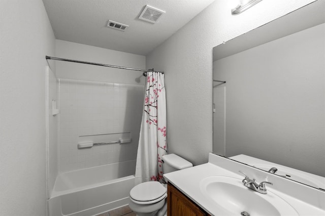 full bathroom with vanity, toilet, a textured ceiling, and shower / bath combo