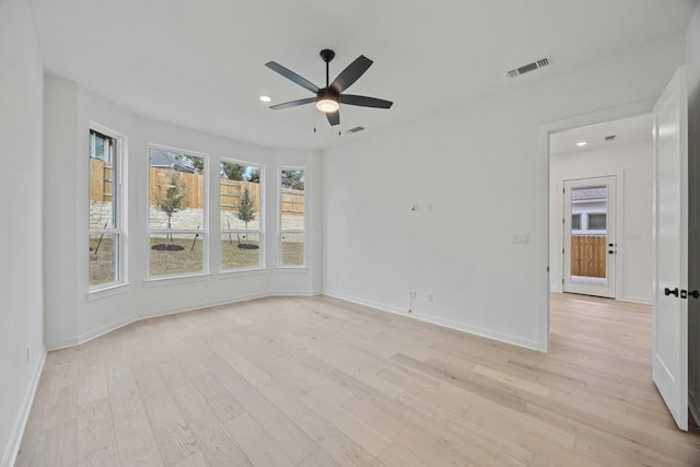 empty room with ceiling fan and light wood-type flooring