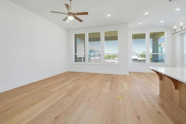 spare room with light wood-style floors, baseboards, a ceiling fan, and recessed lighting