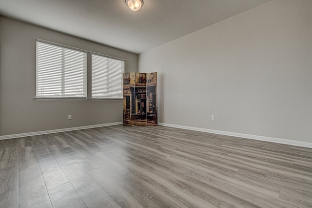 unfurnished room with a fireplace and light hardwood / wood-style floors