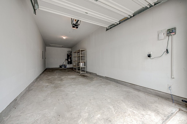 garage with a garage door opener and water heater