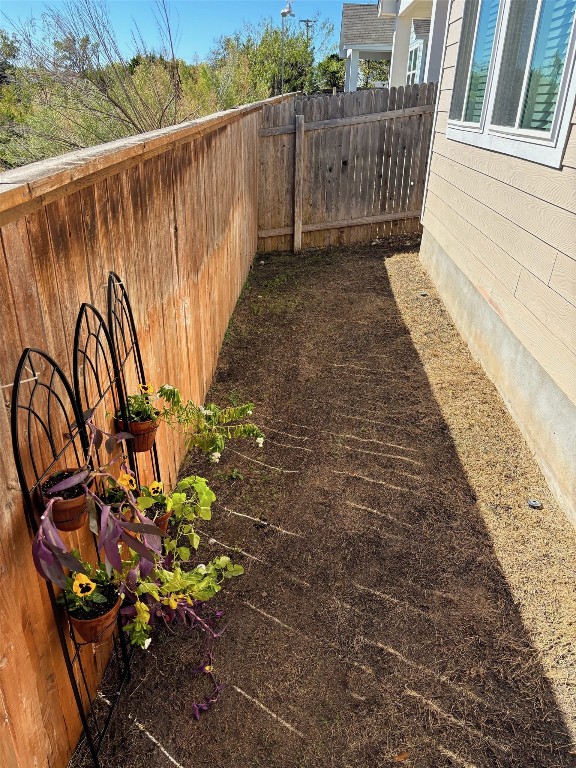 view of yard with a fenced backyard