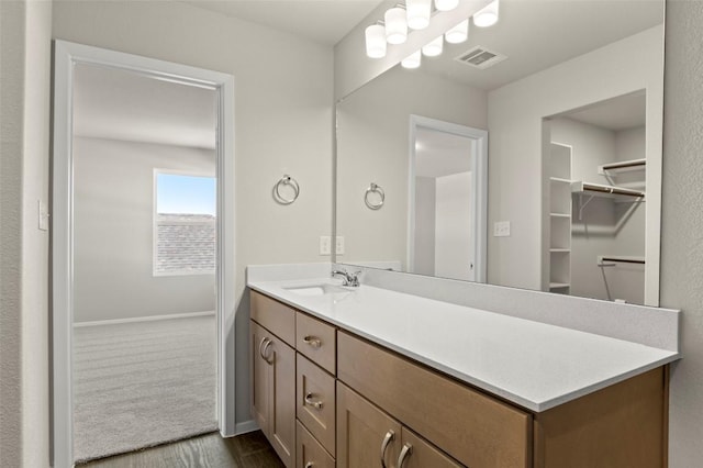 160 Lavender Ln, Elgin, TX 78621 - bathroom featuring wood finished floors, vanity, and baseboards