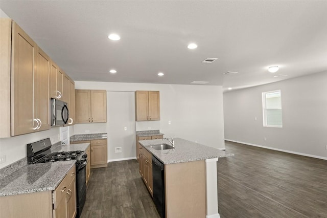 160 Lavender Ln, Elgin, TX 78621 - kitchen with black appliances, dark wood finished floors, a sink, baseboards, and a kitchen island with sink