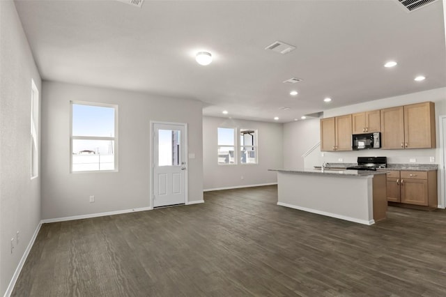160 Lavender Ln, Elgin, TX 78621 - kitchen with range, black microwave, dark wood-type flooring, baseboards, and recessed lighting