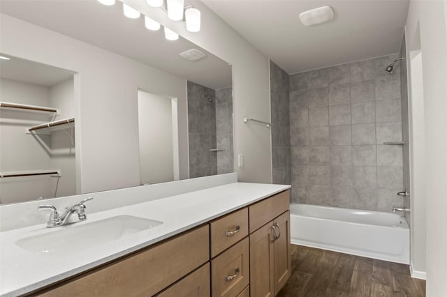 160 Lavender Ln, Elgin, TX 78621 - full bath with wood finished floors, washtub / shower combination, vanity, and a walk in closet