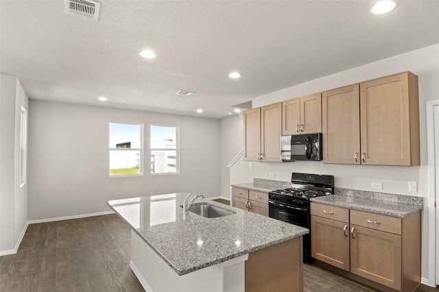 160 Lavender Ln, Elgin, TX 78621 - kitchen featuring black appliances, a sink, dark wood-type flooring, a center island with sink, and recessed lighting