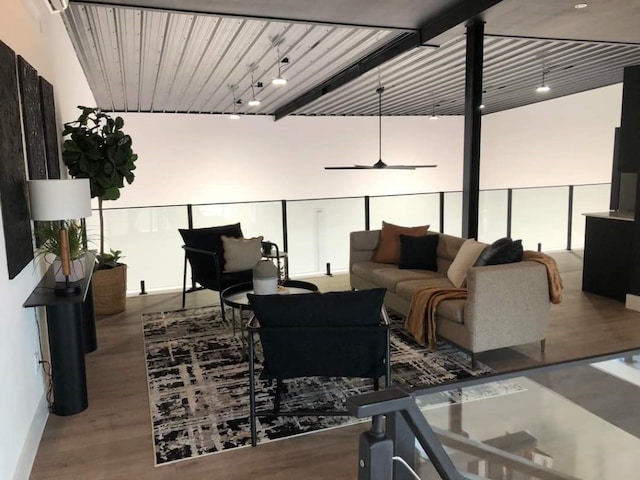 living room with hardwood / wood-style floors and track lighting