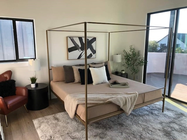 bedroom featuring access to outside and hardwood / wood-style floors