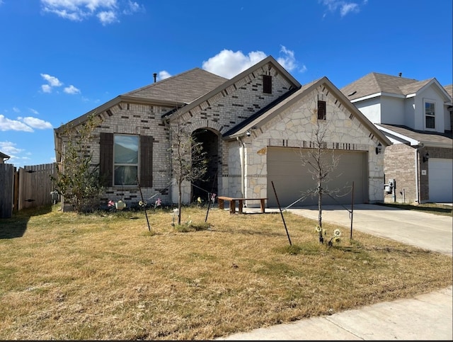 view of front of property with a front yard and a garage