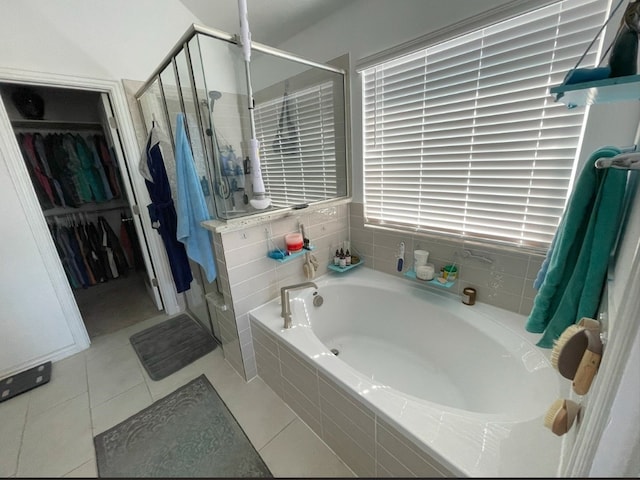 bathroom with tile patterned flooring and shower with separate bathtub