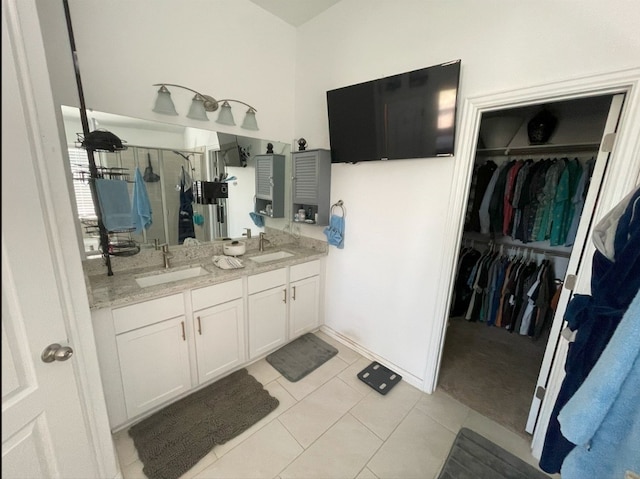 bathroom with vanity, an enclosed shower, and tile patterned flooring