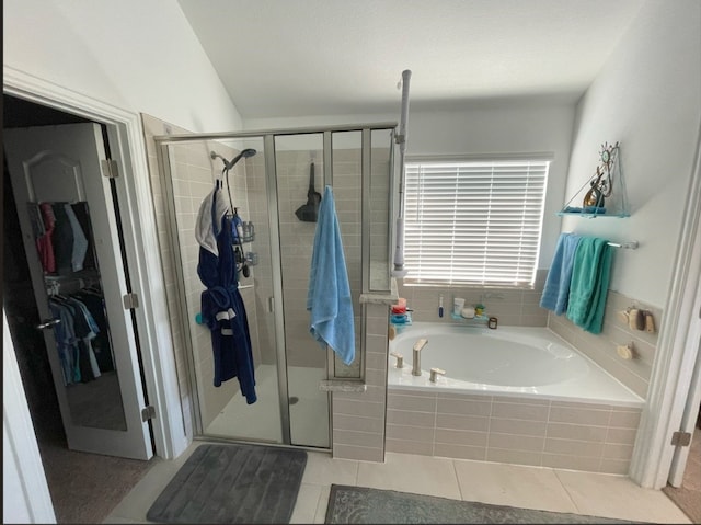 bathroom featuring separate shower and tub and tile patterned floors