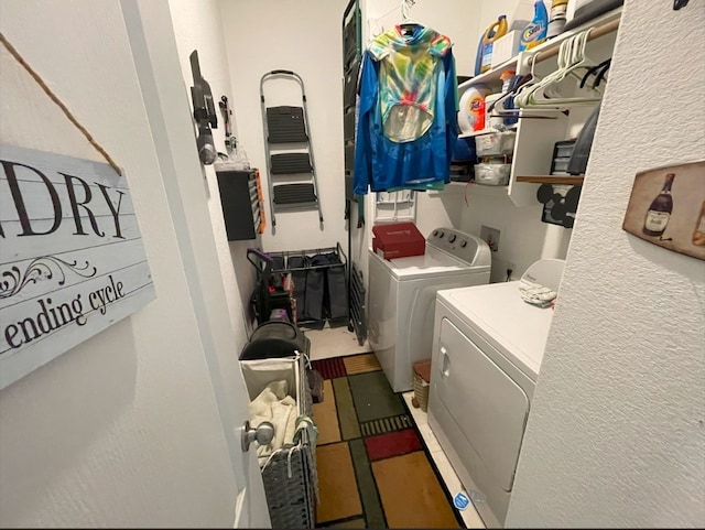 clothes washing area with washer and clothes dryer